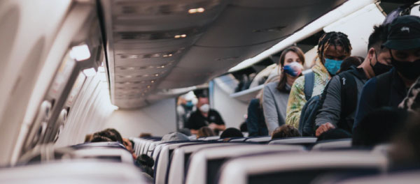 People in Plane with Mask