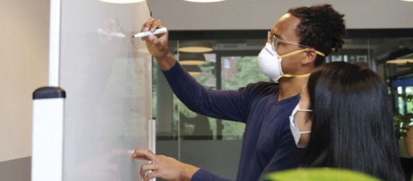 Employees in Masks at white board